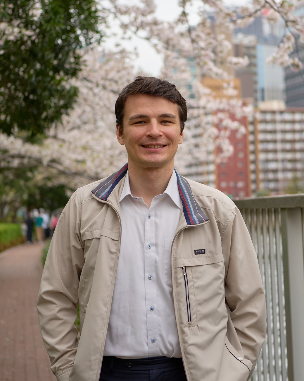 Portrait of Dr. Maksym Grinenko in Tokyo beneath cherry blossoms